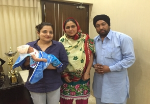 Parents with their newborn and a member of the care team
