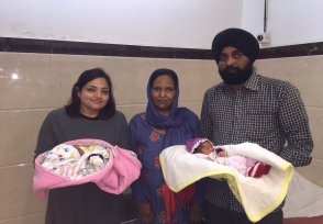 Family holding their newborns with the care team